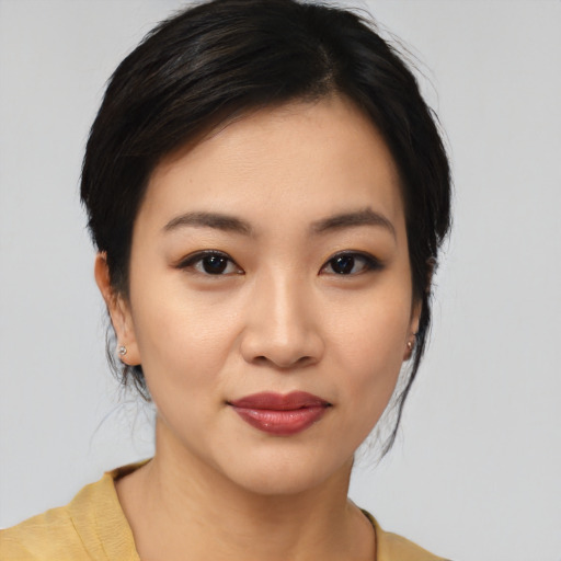 Joyful asian young-adult female with medium  black hair and brown eyes