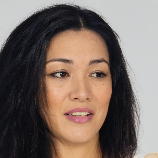 Joyful asian young-adult female with long  brown hair and brown eyes