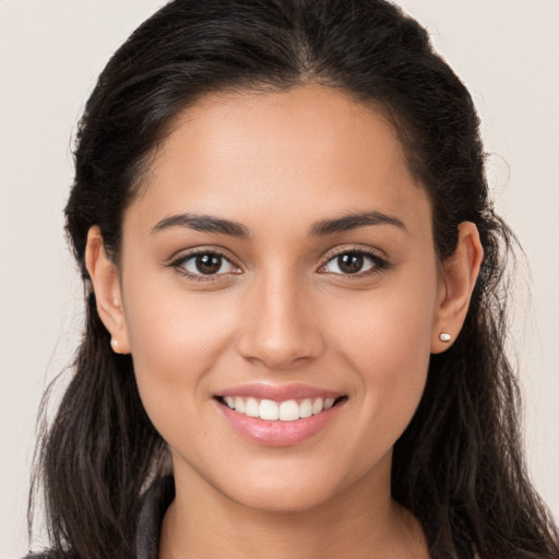 Joyful white young-adult female with long  brown hair and brown eyes