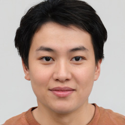 Joyful asian young-adult male with short  brown hair and brown eyes