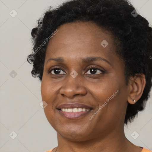 Joyful black adult female with short  brown hair and brown eyes