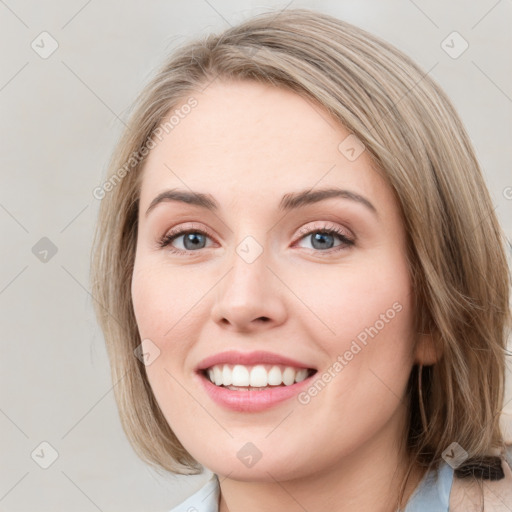 Joyful white young-adult female with medium  brown hair and blue eyes