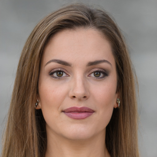 Joyful white young-adult female with long  brown hair and green eyes