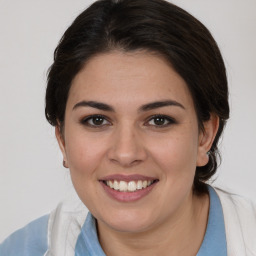 Joyful white young-adult female with medium  brown hair and brown eyes