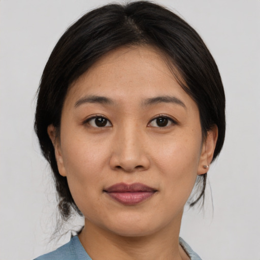 Joyful asian young-adult female with medium  black hair and brown eyes