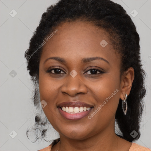 Joyful black young-adult female with medium  brown hair and brown eyes