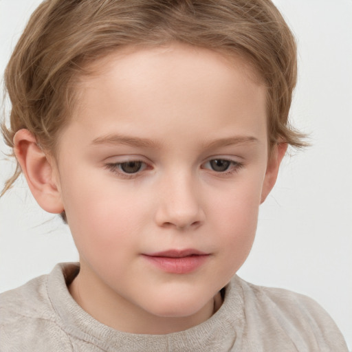 Joyful white child female with short  brown hair and grey eyes