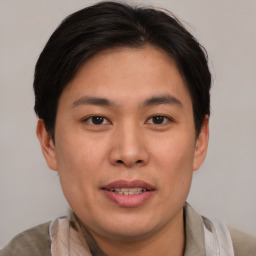 Joyful asian young-adult male with short  brown hair and brown eyes