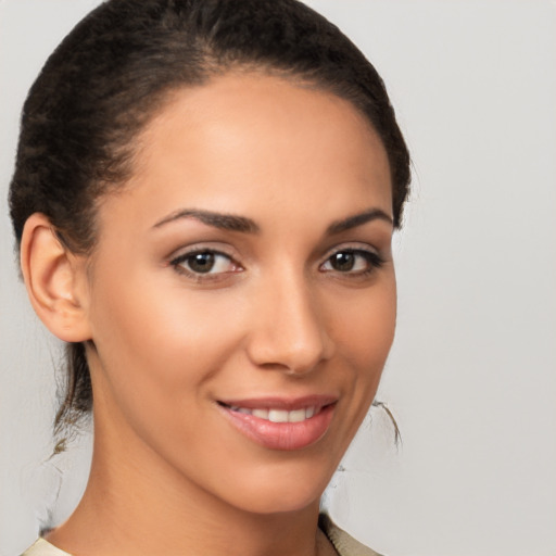 Joyful latino young-adult female with medium  brown hair and brown eyes