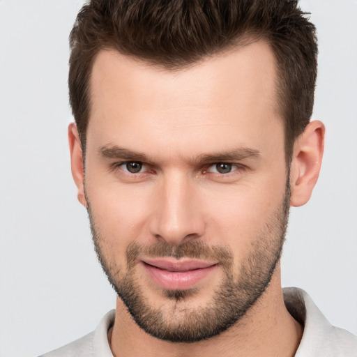 Joyful white young-adult male with short  brown hair and brown eyes