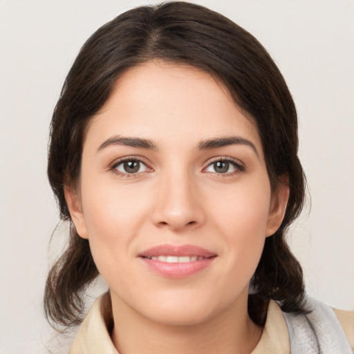 Joyful white young-adult female with medium  brown hair and brown eyes