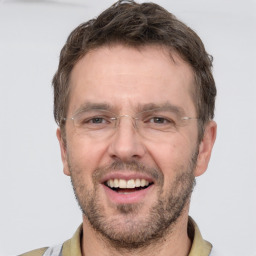 Joyful white adult male with short  brown hair and grey eyes