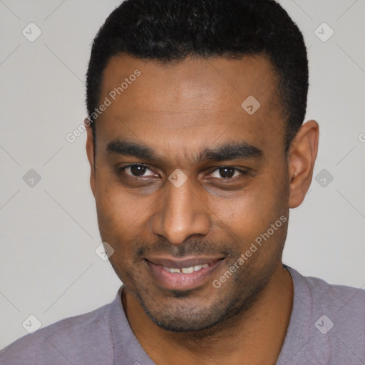 Joyful black young-adult male with short  black hair and brown eyes