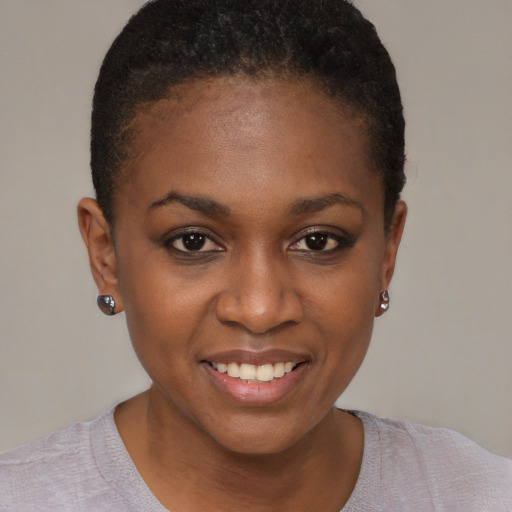Joyful black young-adult female with short  brown hair and brown eyes