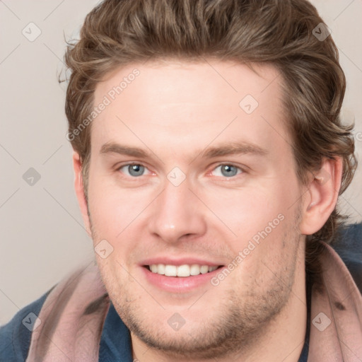 Joyful white young-adult male with short  brown hair and blue eyes