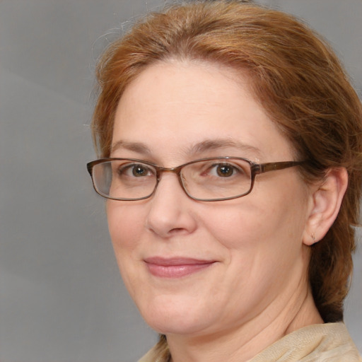 Joyful white adult female with medium  brown hair and blue eyes