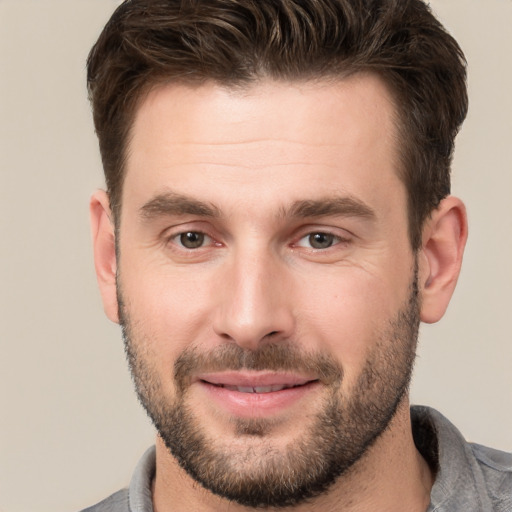 Joyful white young-adult male with short  brown hair and brown eyes