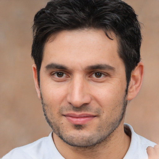 Joyful white young-adult male with short  black hair and brown eyes