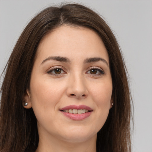 Joyful white young-adult female with long  brown hair and brown eyes