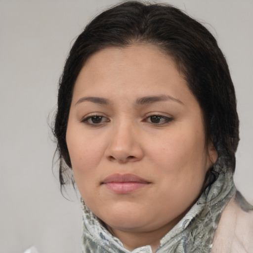 Joyful latino young-adult female with medium  brown hair and brown eyes
