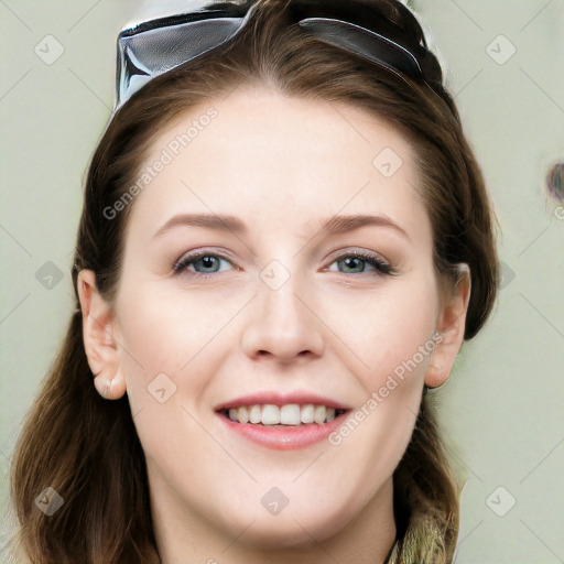 Joyful white young-adult female with long  brown hair and blue eyes