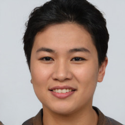 Joyful asian young-adult female with short  brown hair and brown eyes