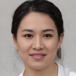 Joyful asian young-adult female with medium  brown hair and brown eyes