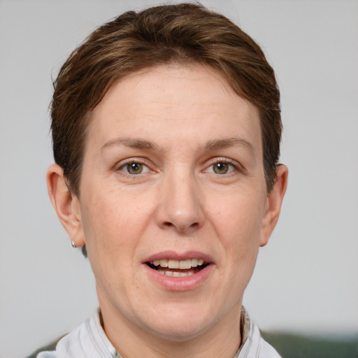 Joyful white adult female with short  brown hair and grey eyes