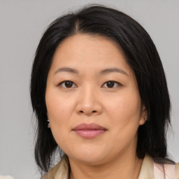 Joyful asian adult female with medium  brown hair and brown eyes