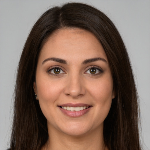 Joyful white young-adult female with long  brown hair and brown eyes