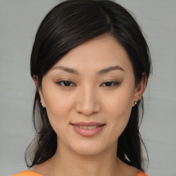 Joyful asian young-adult female with medium  black hair and brown eyes