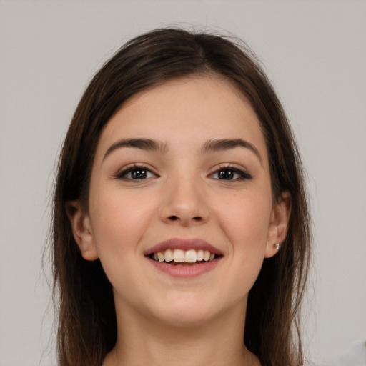 Joyful white young-adult female with long  brown hair and brown eyes