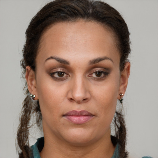 Joyful latino young-adult female with long  brown hair and brown eyes