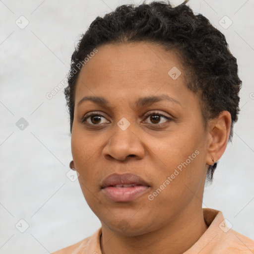 Joyful black young-adult female with short  brown hair and brown eyes