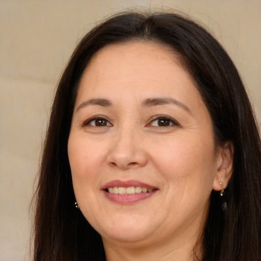Joyful white adult female with long  brown hair and brown eyes
