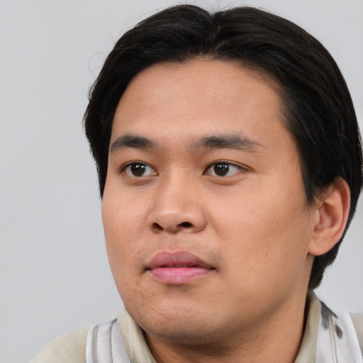Joyful asian young-adult male with short  brown hair and brown eyes