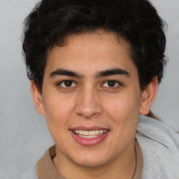 Joyful latino young-adult male with short  brown hair and brown eyes