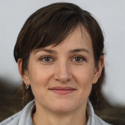 Joyful white adult female with medium  brown hair and brown eyes