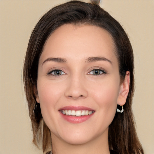 Joyful white young-adult female with long  brown hair and brown eyes