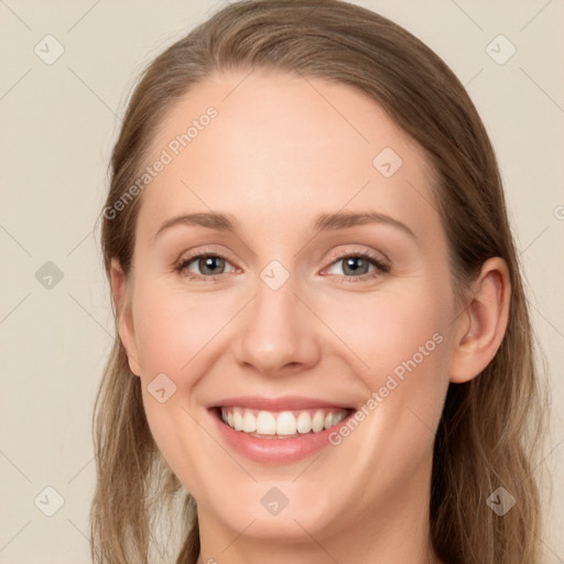 Joyful white young-adult female with long  brown hair and green eyes