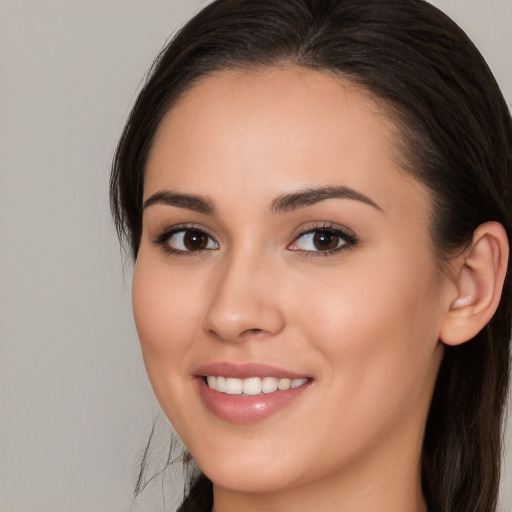 Joyful white young-adult female with long  brown hair and brown eyes