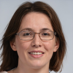 Joyful white adult female with medium  brown hair and grey eyes