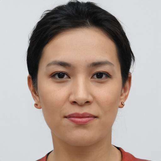 Joyful latino young-adult female with short  brown hair and brown eyes