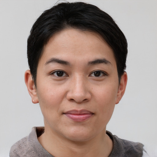 Joyful asian young-adult female with short  brown hair and brown eyes
