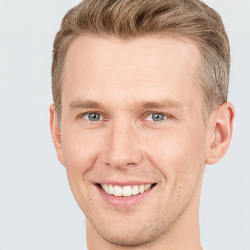 Joyful white adult male with short  brown hair and grey eyes