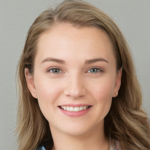 Joyful white young-adult female with long  brown hair and grey eyes