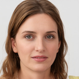 Joyful white young-adult female with medium  brown hair and green eyes