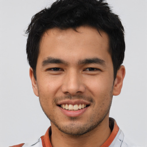 Joyful asian young-adult male with short  brown hair and brown eyes
