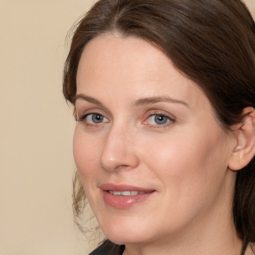 Joyful white adult female with medium  brown hair and brown eyes