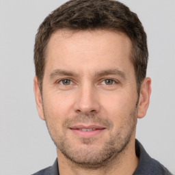 Joyful white young-adult male with short  brown hair and brown eyes